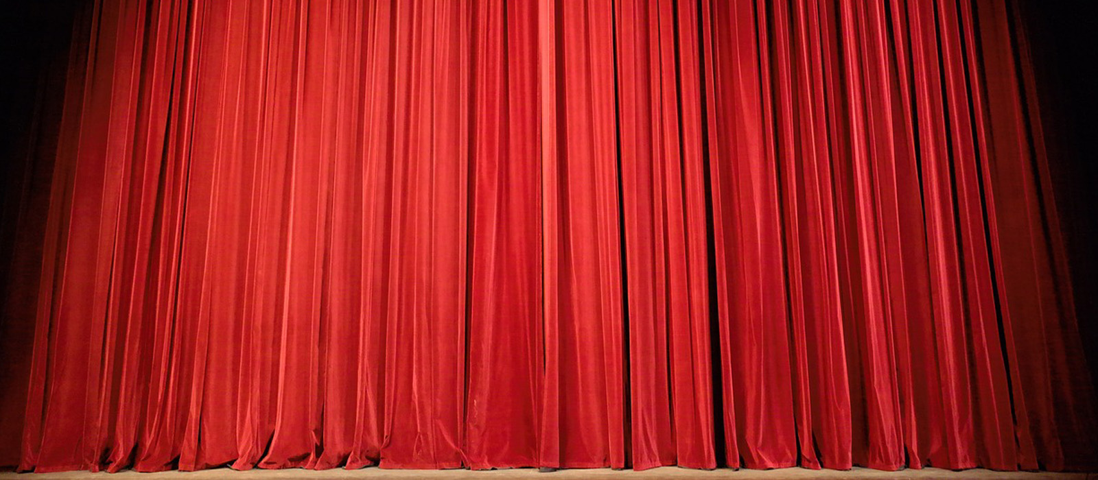 A red theatre curtain and stage