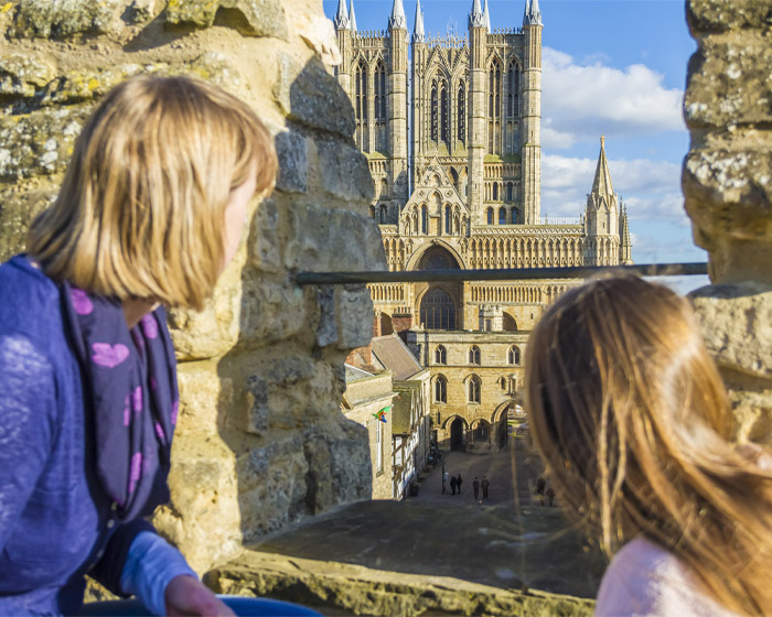 Two children on Lincoln Castle wall look across at Lincoln Cathedral