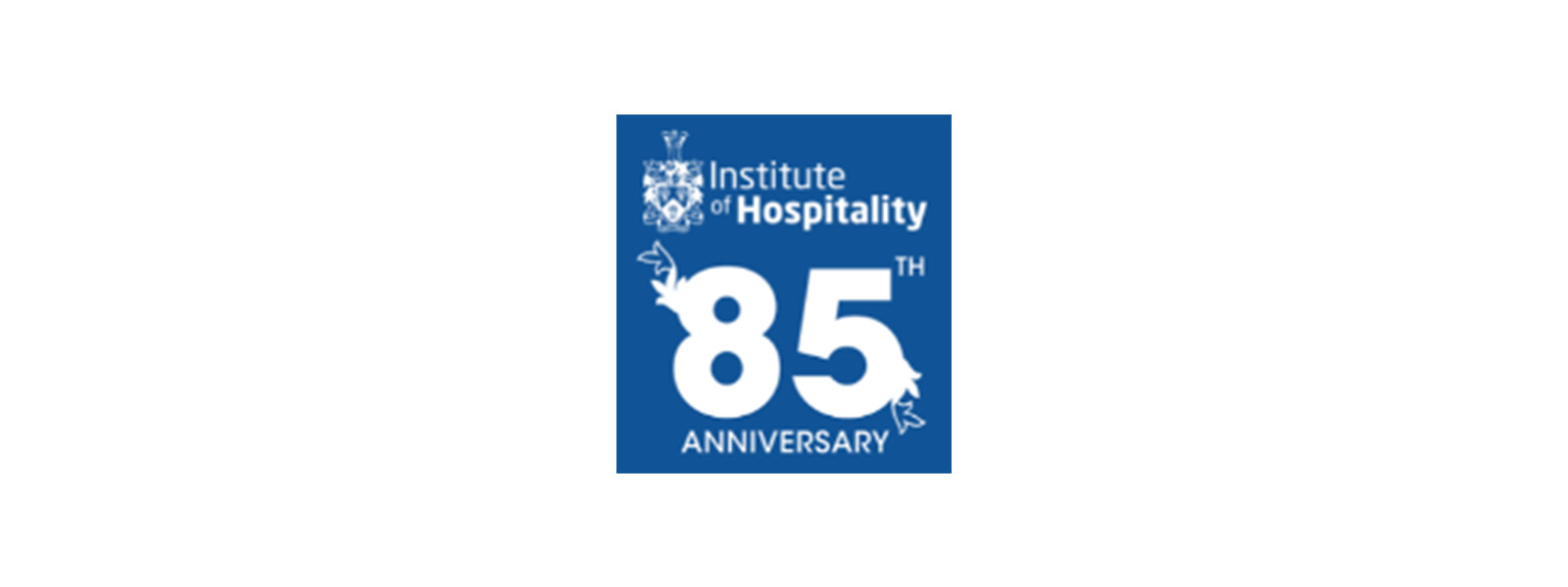 A blue square with Institute of Hospitality 85th Anniversary written inside