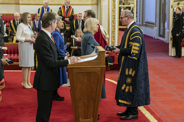 Queen Camilla presenting the anniversary award to Professor Neal Juster