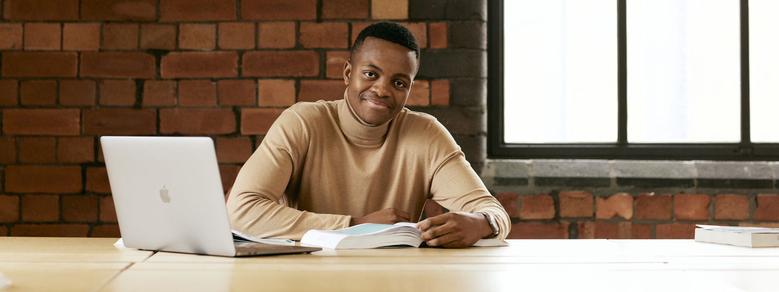 Student with a laptop studying in the library