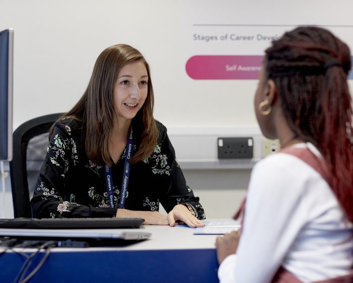 A member of staff speaking with a student