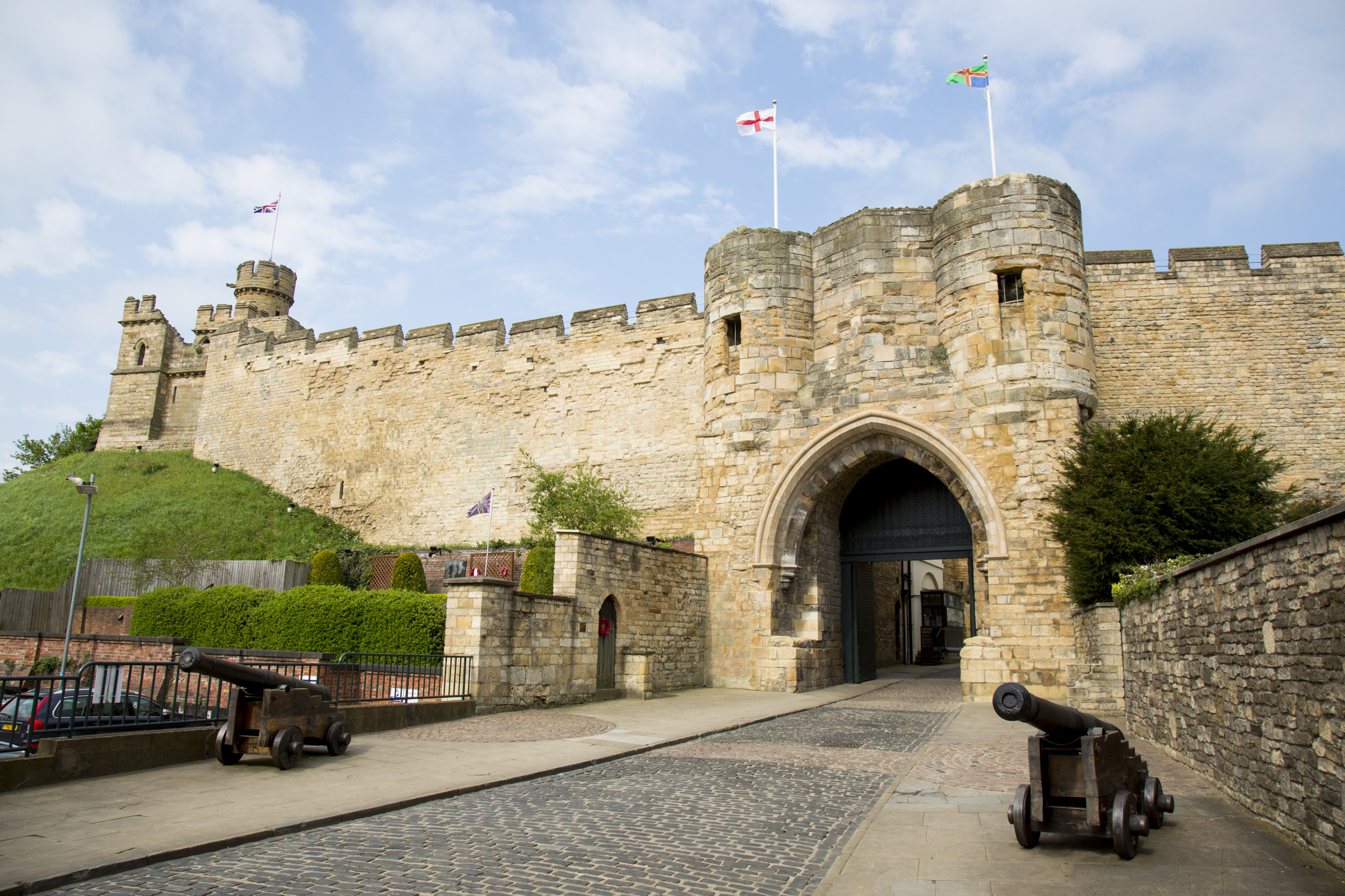 Front of Lincoln Castle, with two black cannons positioned wither side of the entrance