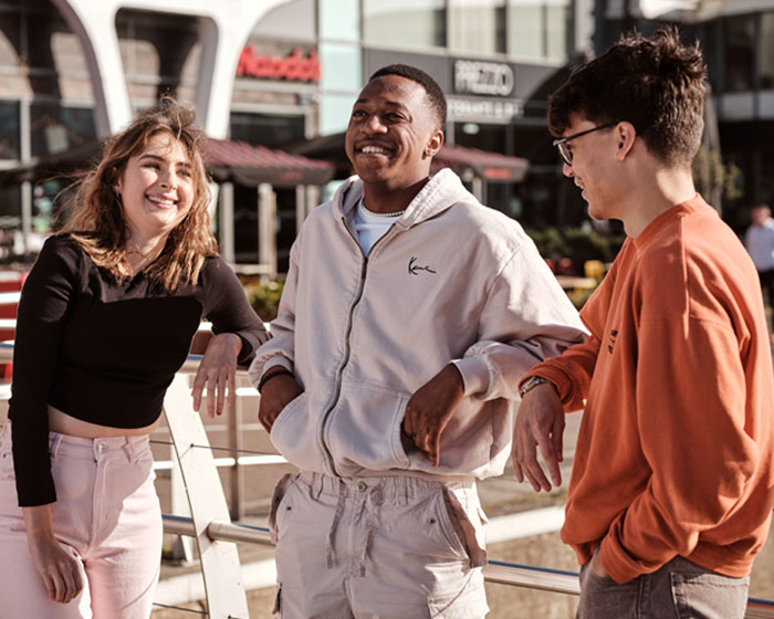 A group of students chatting on Brayford waterfront