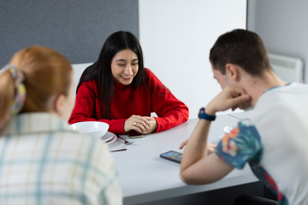 A group of students sat around a table in University accommodation