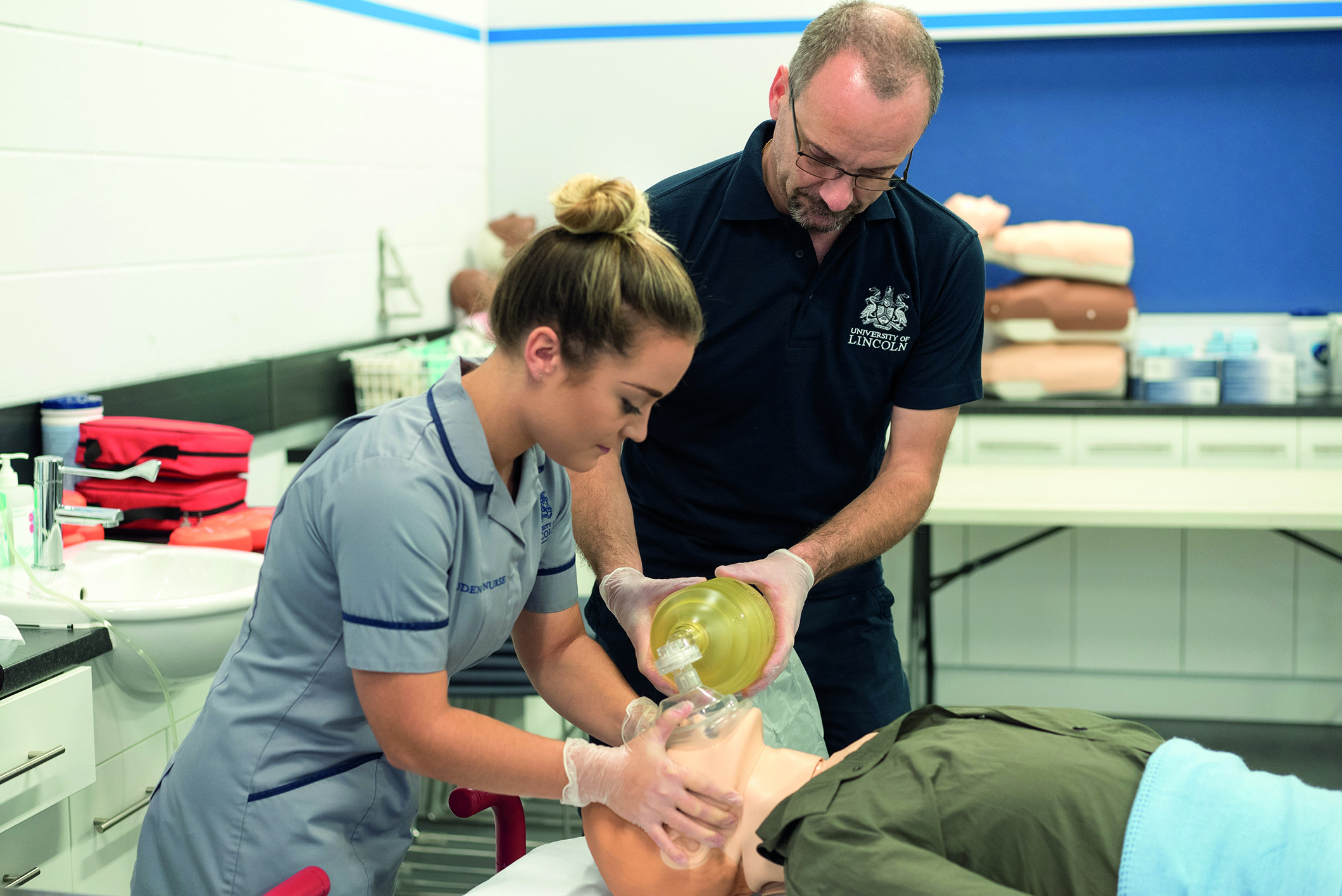 A student nurse practice using a manual resuscitation pump.