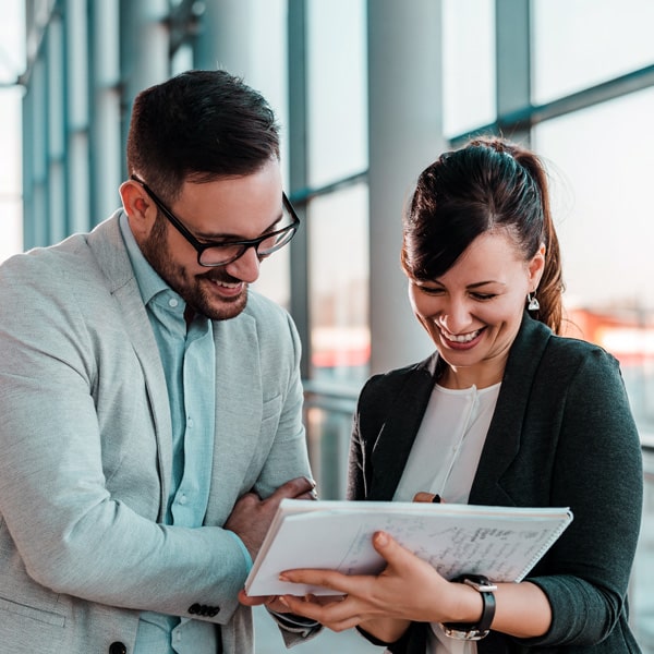 Man and woman talking around a piece of paper