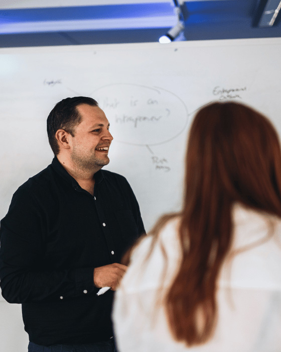 Shows a mentoring session between two people