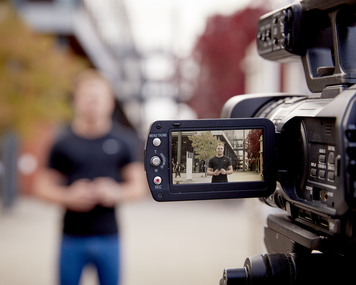 A student recording a video news piece