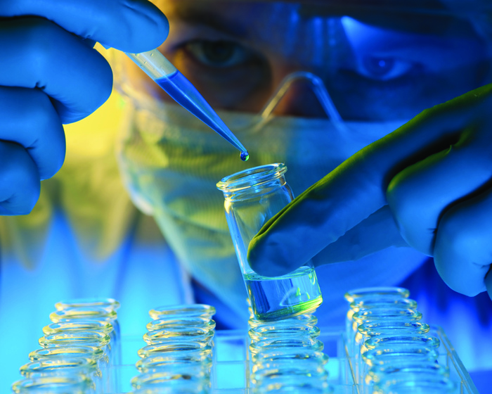 A scientist with a row of test tubes