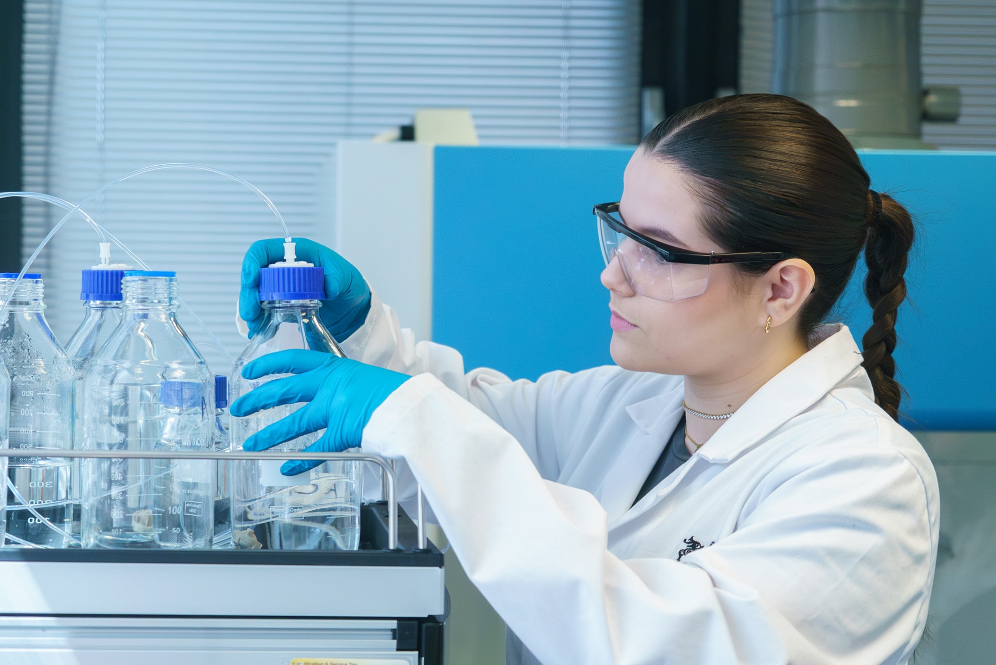 A student analysing beakers in a lab