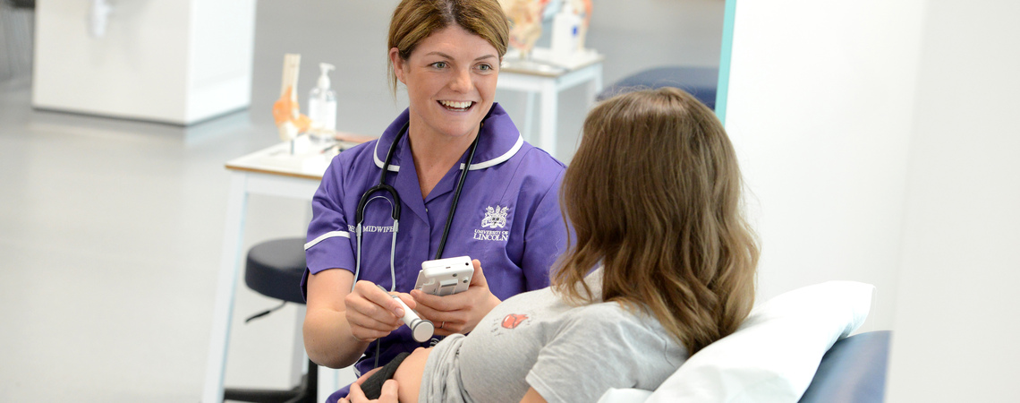 Student midwife in a mock hospital environment