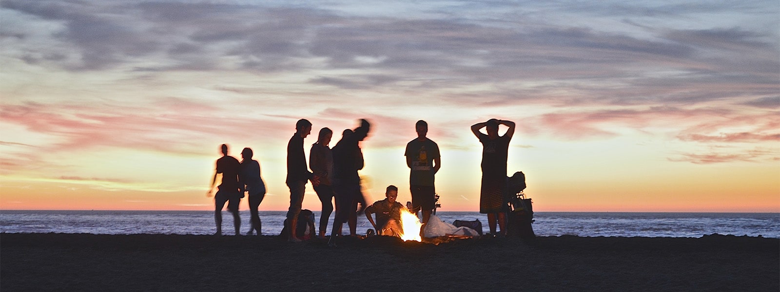 People in silhouette on a beach