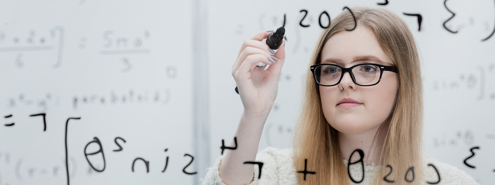 A student writing on a board