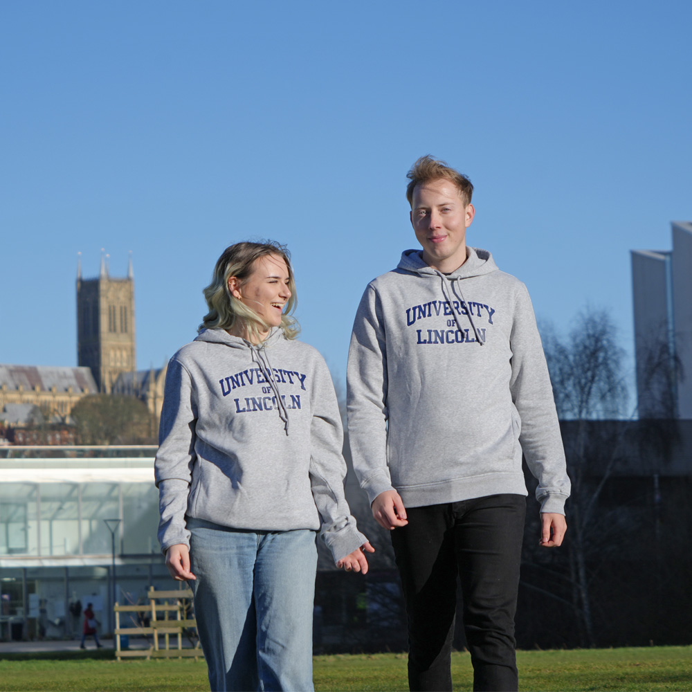 Two students wearing university hoodies