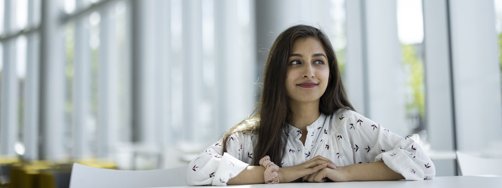 A student sitting in the Isaac Newton Building