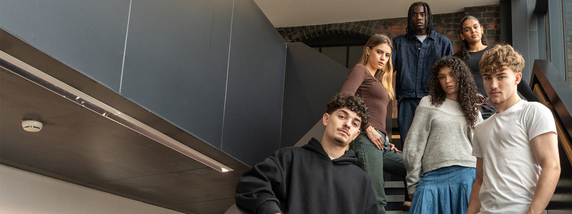 A group of students posing on a set of stairs