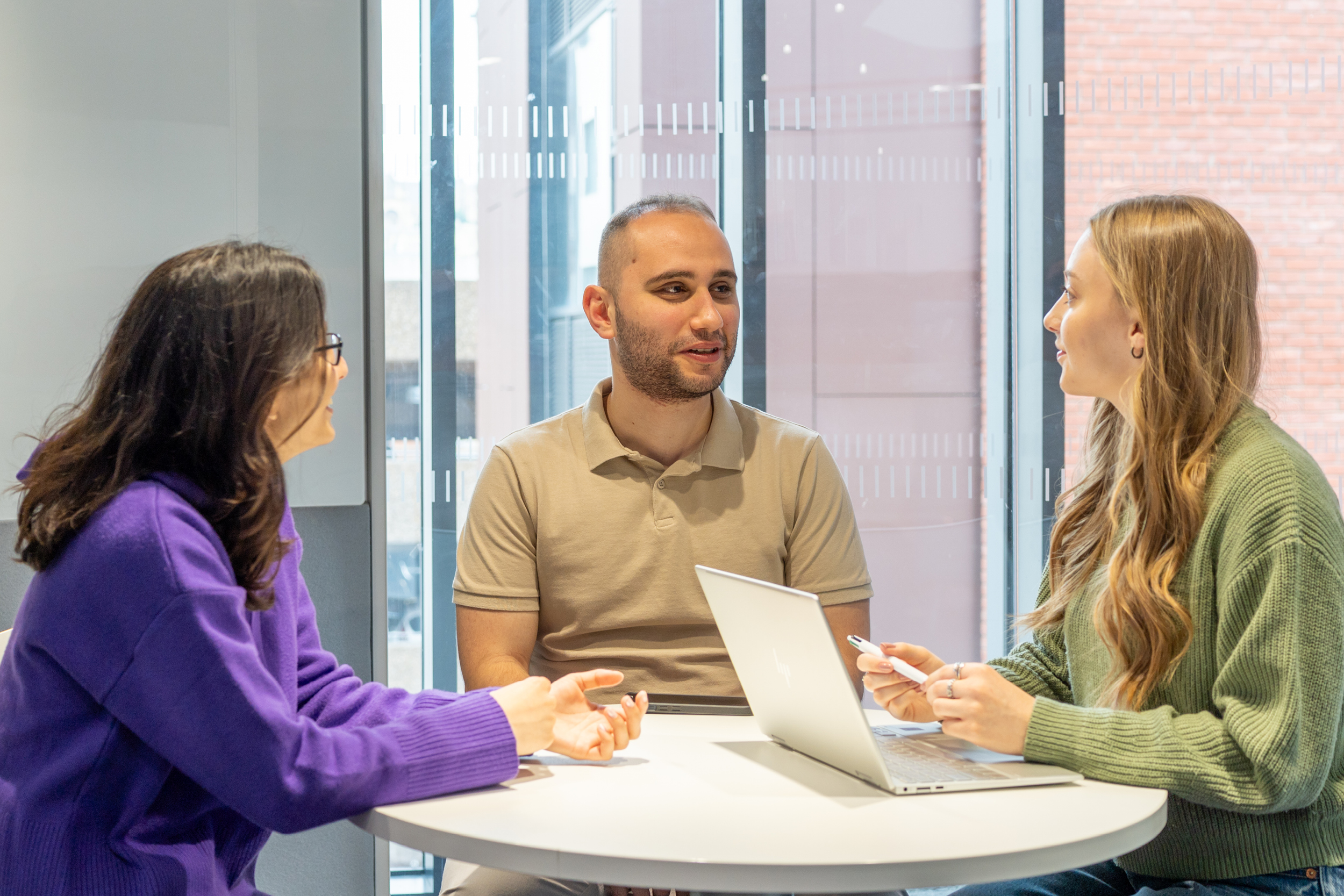 three students at a table