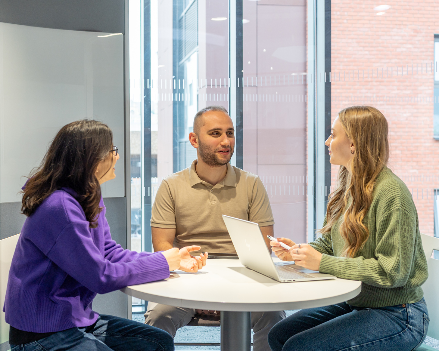 three students sat at a table