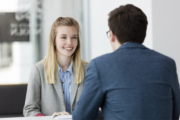 Two people in conversation across a table