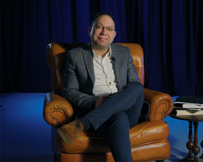 Ben Wajdi sat in an armchair with his legs crossed and smiling
