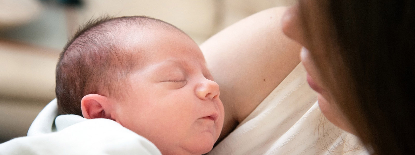 A mother holding a baby in her arms