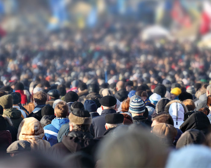 A crowd of people walking down a street