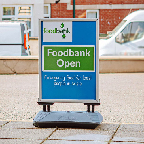 A foodbank sign on the pavement