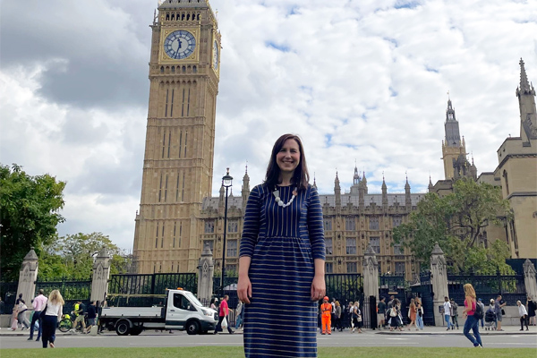 Professor Hanya Pielichaty standing outside the Houses of Parliament