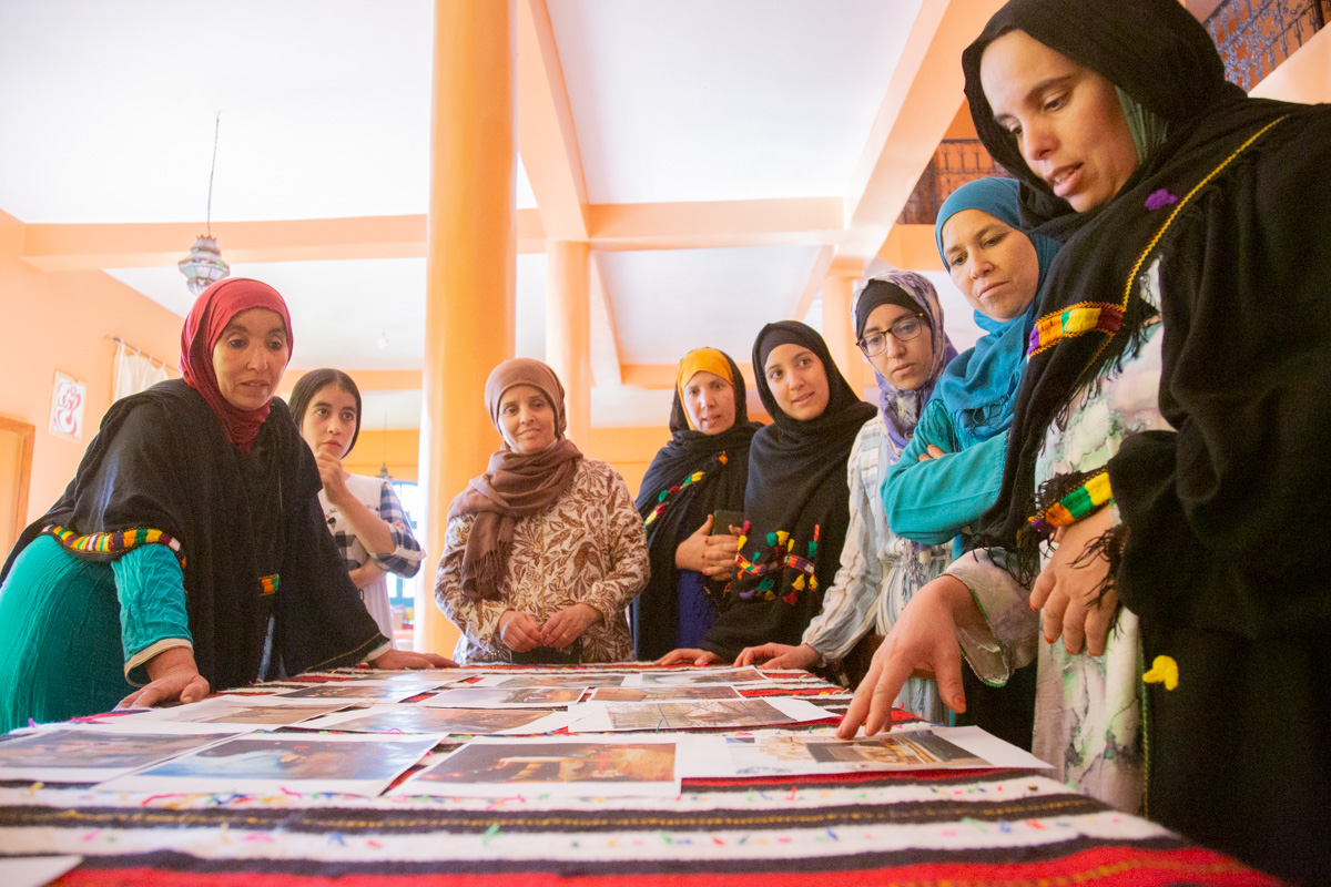 A group of women studying photographs