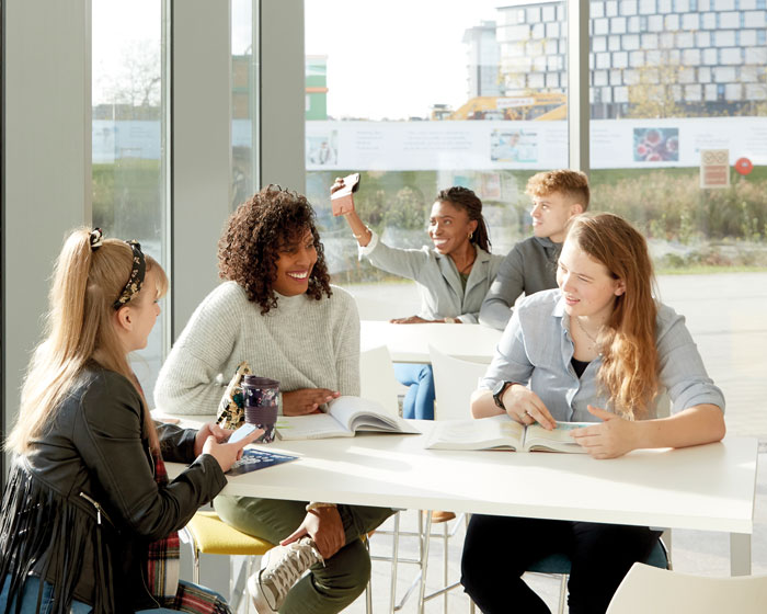 A group of students chatting in a cafe