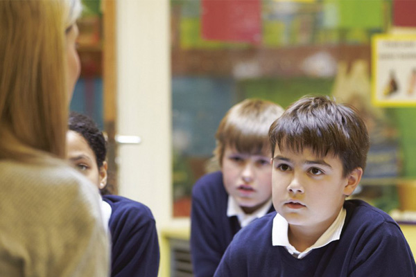 A teacher with a group of pupils in a classroom