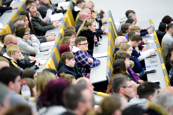 People sat in a lecture theatre listening