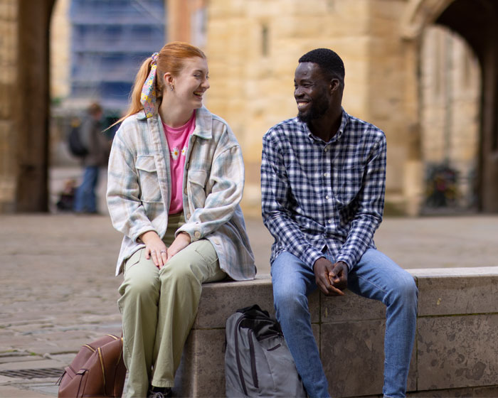 Two students chatting in the city centre